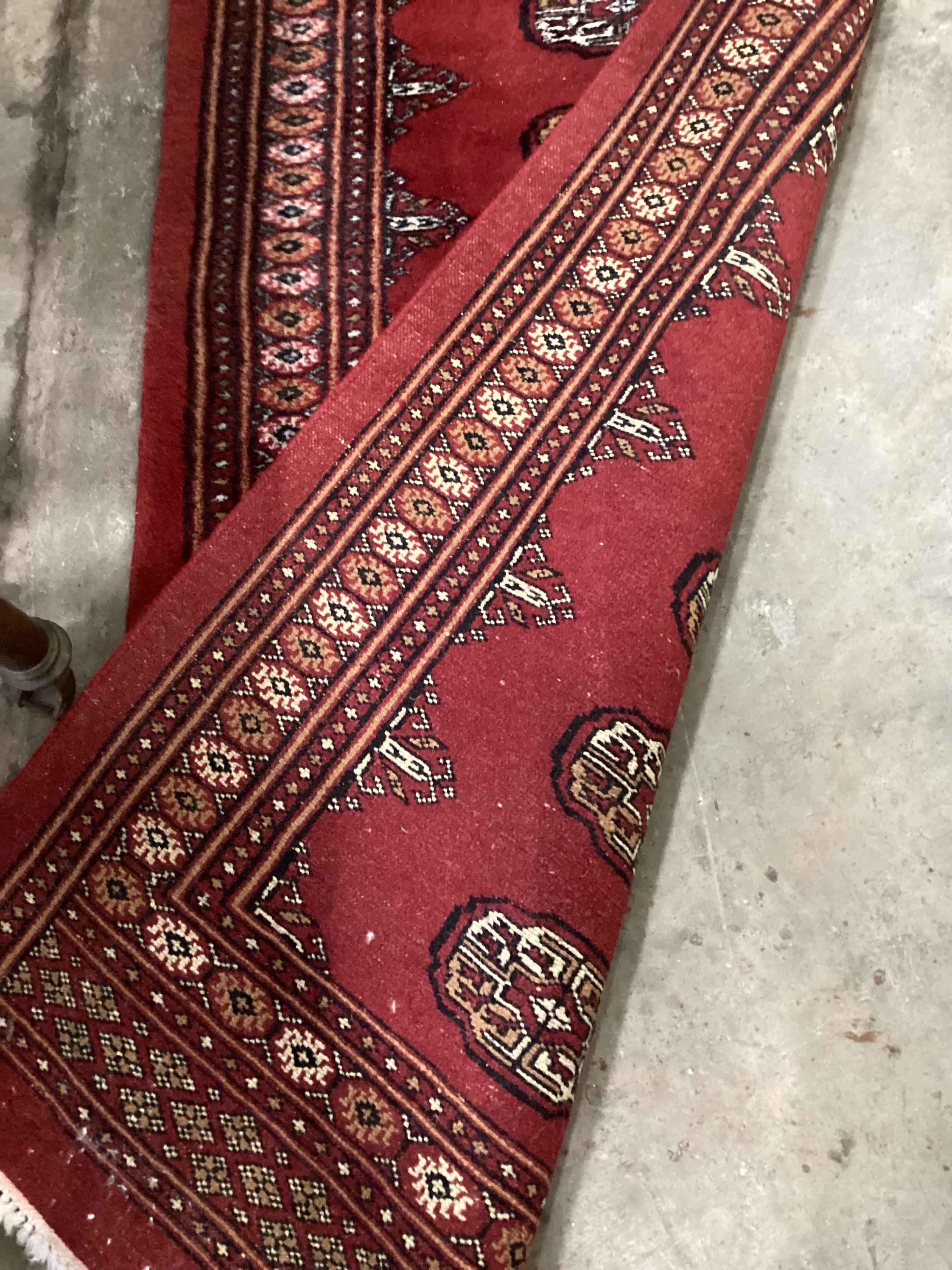 A Bokhara red ground runner, 276 x 82cm